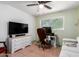 Cozy bedroom features a ceiling fan, tile flooring, and a versatile workspace with natural light at 1308 N 66Th St, Scottsdale, AZ 85257