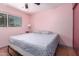 A pink bedroom features a window, ceiling fan, and bed at 1308 N 66Th St, Scottsdale, AZ 85257