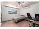 A cozy bedroom includes a ceiling fan and a window for natural light at 1308 N 66Th St, Scottsdale, AZ 85257