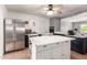 Well-lit kitchen includes stainless steel appliances and a movable island with seating at 1308 N 66Th St, Scottsdale, AZ 85257