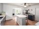 Bright kitchen boasts tile flooring, stainless appliances, an island and an opening to the dining area at 1308 N 66Th St, Scottsdale, AZ 85257