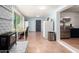 Bright open kitchen features stainless steel appliances, white brick accent wall and dining space at 1308 N 66Th St, Scottsdale, AZ 85257
