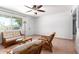 Inviting living room with tile flooring, ceiling fan, and comfortable wicker furniture at 1308 N 66Th St, Scottsdale, AZ 85257