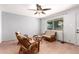 Inviting living room with tile flooring, ceiling fan, and comfortable wicker furniture at 1308 N 66Th St, Scottsdale, AZ 85257