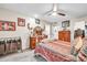 Cozy bedroom with a ceiling fan, dresser, a decorative mirror, and neutral paint at 13428 N Hawthorn Dr, Sun City, AZ 85351