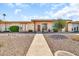 Charming home with well-kept landscaping, desert rocks, and a concrete walkway at 13428 N Hawthorn Dr, Sun City, AZ 85351