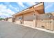 Exterior view of the garage doors to the units with an adjacent gate and landscaping at 13428 N Hawthorn Dr, Sun City, AZ 85351