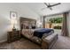 Comfortable bedroom featuring a cozy bed, ceiling fan and tranquil views of the outdoors at 14835 N 41St Pl, Phoenix, AZ 85032