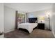 Cozy bedroom with carpet flooring and a window looking out into greenery at 14835 N 41St Pl, Phoenix, AZ 85032