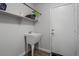 Laundry room with utility sink and shelving at 14835 N 41St Pl, Phoenix, AZ 85032