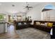 Spacious living area featuring a large sofa, modern ceiling fan, and plenty of natural light at 14835 N 41St Pl, Phoenix, AZ 85032