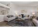 Comfortable living room featuring stylish furnishings, neutral color palette, and wood-look flooring at 14835 N 41St Pl, Phoenix, AZ 85032