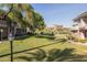 Lush backyard with green grass and mature trees; perfect for outdoor activities and relaxation at 15221 N Clubgate Dr # 2139, Scottsdale, AZ 85254