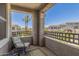 Relaxing balcony with a chair, table, and view of the community landscaping and surrounding buildings at 15221 N Clubgate Dr # 2139, Scottsdale, AZ 85254