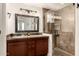 Bathroom featuring a double sink vanity and walk-in shower with tiled walls at 15221 N Clubgate Dr # 2139, Scottsdale, AZ 85254