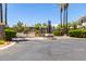 Community entry gate with lush landscaping and decorative lighting, ensuring privacy and security at 15221 N Clubgate Dr # 2139, Scottsdale, AZ 85254