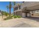 Exterior view of a two car garage with tropical landscaping and driveway in a well-maintained community at 15221 N Clubgate Dr # 2139, Scottsdale, AZ 85254