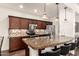 Kitchen featuring dark wood cabinets, granite countertops, stainless steel appliances, and a breakfast bar at 15221 N Clubgate Dr # 2139, Scottsdale, AZ 85254