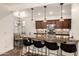 Kitchen featuring granite countertops, dark wood cabinets, stainless steel appliances, and a breakfast bar at 15221 N Clubgate Dr # 2139, Scottsdale, AZ 85254