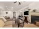 Open concept living room showing fireplace, kitchen bar, hardwood floors and comfortable seating at 15221 N Clubgate Dr # 2139, Scottsdale, AZ 85254