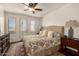 Cozy main bedroom with ceiling fan, an exterior door, and a decorative rug at 15221 N Clubgate Dr # 2139, Scottsdale, AZ 85254