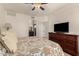 This main bedroom has a ceiling fan, carpet, and a doorway to the bathroom at 15221 N Clubgate Dr # 2139, Scottsdale, AZ 85254