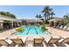 Community pool with lounge chairs and palm trees, perfect for relaxation and enjoying the sun at 15221 N Clubgate Dr # 2139, Scottsdale, AZ 85254