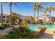Beautiful community pool surrounded by lush landscaping and palm trees, offering a tranquil retreat at 15221 N Clubgate Dr # 2139, Scottsdale, AZ 85254