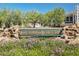 Community sign for Kierland Greens, surrounded by colorful flowers and well-maintained landscaping at 15221 N Clubgate Dr # 2139, Scottsdale, AZ 85254