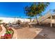 Expansive backyard with stone waterfall, seating, spiral staircase, and lush landscaping at 1611 W Palomino Dr, Chandler, AZ 85224