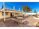 Backyard patio featuring stone furnishings, white exterior, and spiral staircase at 1611 W Palomino Dr, Chandler, AZ 85224