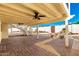 Comfortable outdoor patio with ceiling fans, decorative landscaping, and stone furnishings at 1611 W Palomino Dr, Chandler, AZ 85224