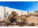 Beautiful backyard stone waterfall surrounded by lush landscaping and brick paving at 1611 W Palomino Dr, Chandler, AZ 85224