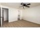 This bedroom features hardwood floors, ceiling fan, and a doorway leading to the rest of the house at 1611 W Palomino Dr, Chandler, AZ 85224
