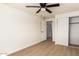 Relax in this spacious bedroom complete with hardwood floors, ceiling fan, and closet at 1611 W Palomino Dr, Chandler, AZ 85224