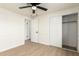 This bedroom boasts hardwood floors, a ceiling fan, closet, and a doorway for convenience at 1611 W Palomino Dr, Chandler, AZ 85224