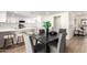 Elegant dining space with a sleek table, comfortable seating, and a view of the modern kitchen at 1611 W Palomino Dr, Chandler, AZ 85224
