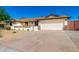 Charming single-story home with desert landscaping, a stone facade, and a two-car garage at 1611 W Palomino Dr, Chandler, AZ 85224