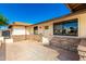 Exterior view of charming home with stone facade, new windows and neutral color palette at 1611 W Palomino Dr, Chandler, AZ 85224