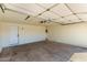 Clean garage interior with a white door, concrete floors, and overhead lighting at 1611 W Palomino Dr, Chandler, AZ 85224