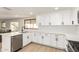 Clean kitchen with stainless appliances, white cabinets, and an island perfect for dining and food prep at 1611 W Palomino Dr, Chandler, AZ 85224