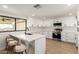 Bright kitchen featuring white cabinets, quartz countertops, stainless steel appliances, and breakfast bar seating at 1611 W Palomino Dr, Chandler, AZ 85224