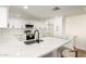 Modern kitchen with white cabinets, stainless steel appliances, and a stylish island with bar seating at 1611 W Palomino Dr, Chandler, AZ 85224