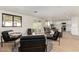 Bright, open living room with modern furnishings and a seamless flow to the dining and kitchen areas at 1611 W Palomino Dr, Chandler, AZ 85224