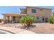 Tan stucco two-story home with desert landscaping and small palm tree at 16217 N 154Th Dr, Surprise, AZ 85374