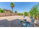 Spacious backyard with paver patio, lush landscaping, and mature trees, perfect for outdoor living at 16217 N 154Th Dr, Surprise, AZ 85374
