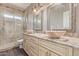 Dual vanity bathroom with granite countertops, stylish fixtures, and walk-in shower at 16217 N 154Th Dr, Surprise, AZ 85374