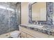 Bathroom showcasing granite countertops, a unique mirror and a glass shower at 16217 N 154Th Dr, Surprise, AZ 85374