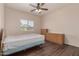 Bedroom with hardwood floors, a ceiling fan, and natural wood furniture at 16217 N 154Th Dr, Surprise, AZ 85374