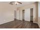 Bedroom featuring hardwood floors, ceiling fan, and closet with sliding doors at 16217 N 154Th Dr, Surprise, AZ 85374